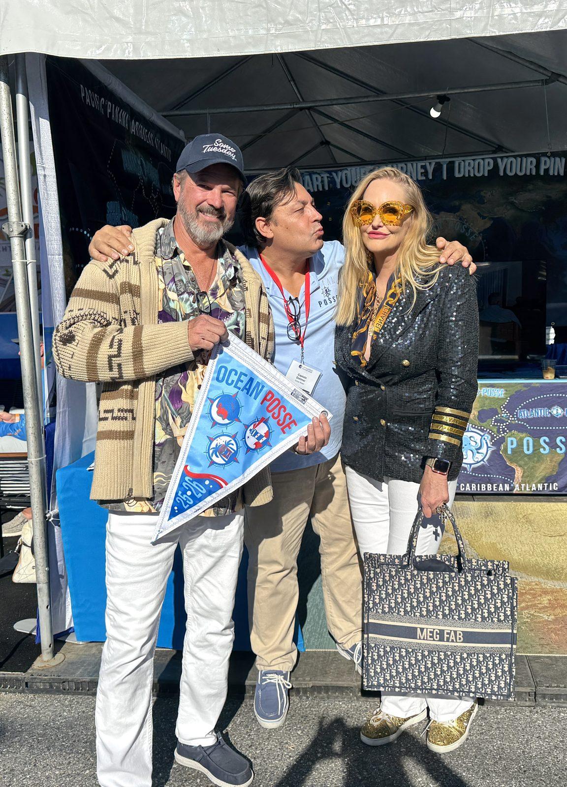 Steve and Meghan with Dietmar, who runs Ocean Posse, receiving their official Ocean Posse burgee at the Annapolis Boat Show in October 2025