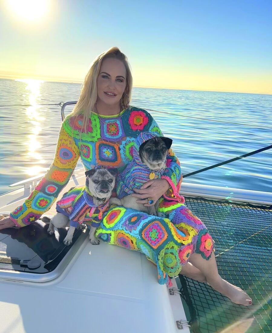 Meghan on the bow of Some Tuesday with Mr. Pickles and Colonel Mustard in matching crochet sweaters