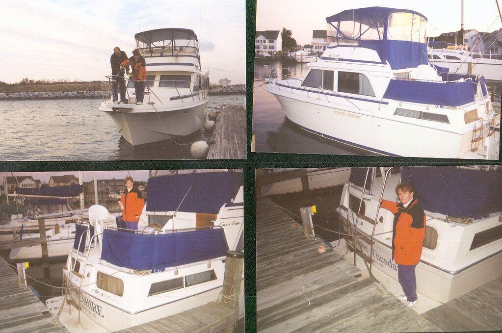 A white motor cruiser named Some Tuesday on a trailer, with the family standing beside the truck
