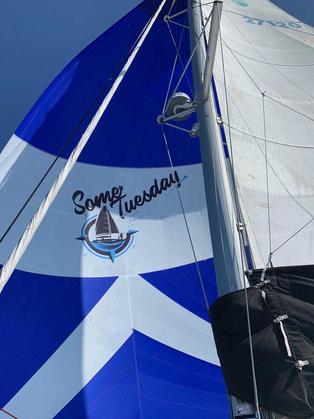 Some Tuesday's blue and white spinnaker with the boat's logo