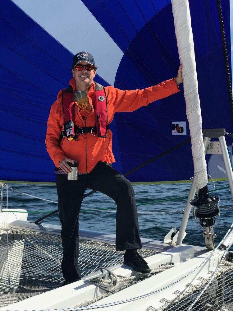 Steve in offshore foul-weather gear and a life jacket at the mast