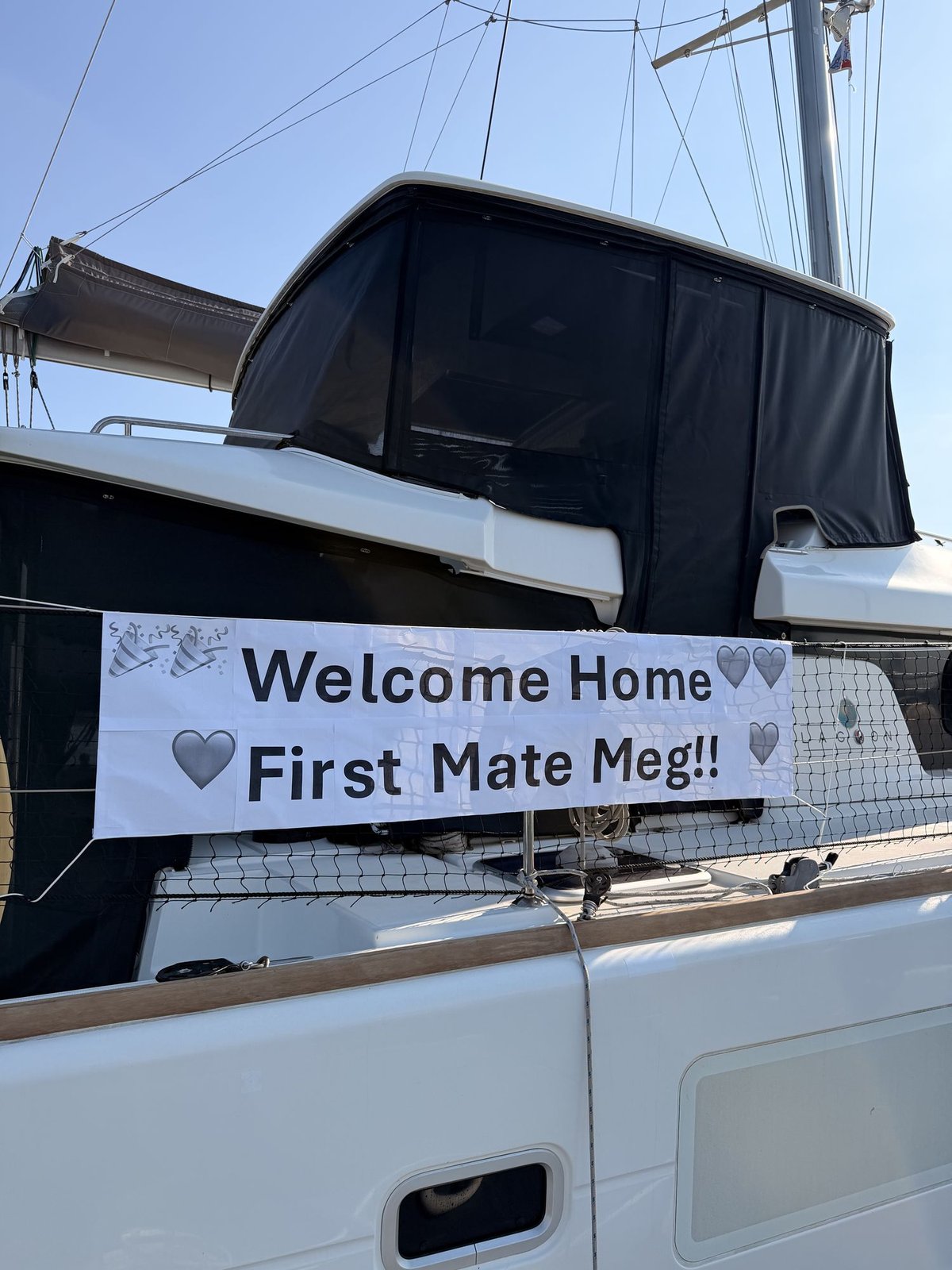A banner on the side of the boat reading Welcome home First Mate Meg