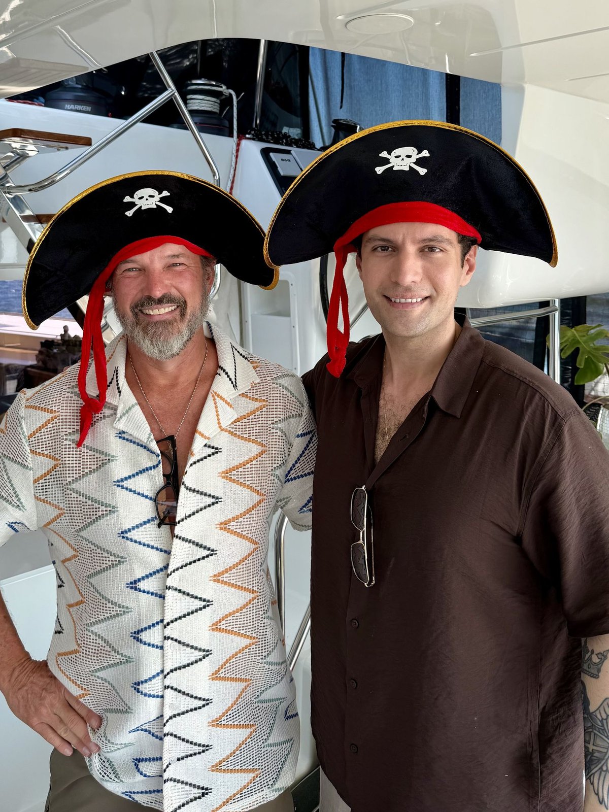 Captain Steve, left, and Herbert in pirate hats on the boat