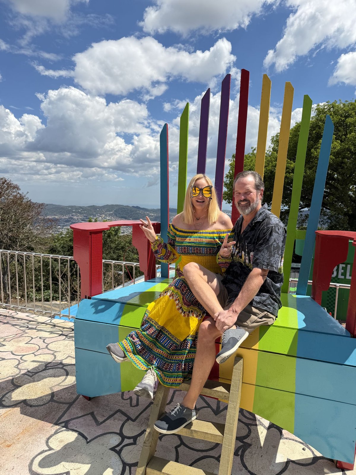 Steve and Meghan sitting on a giant rainbow chair at Picnic Steak House