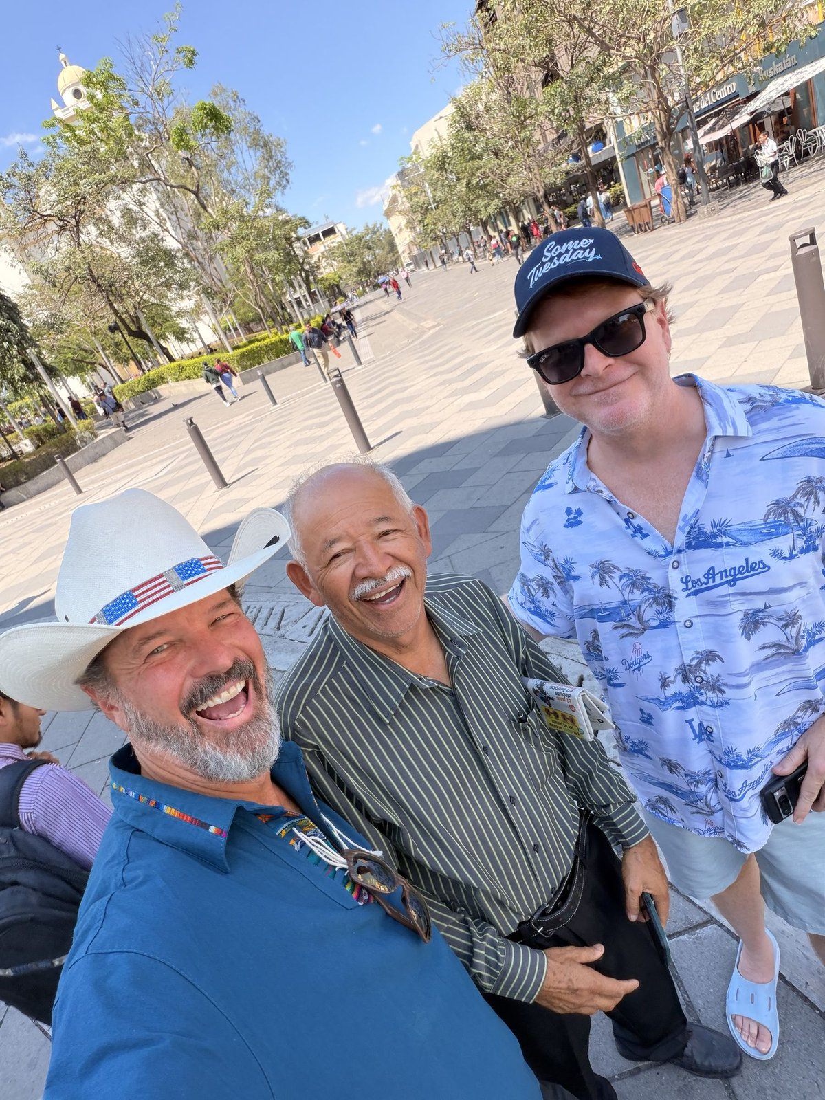 Pat, Captain Steve, and the driver they hired, standing in a plaza with the cathedral behind them