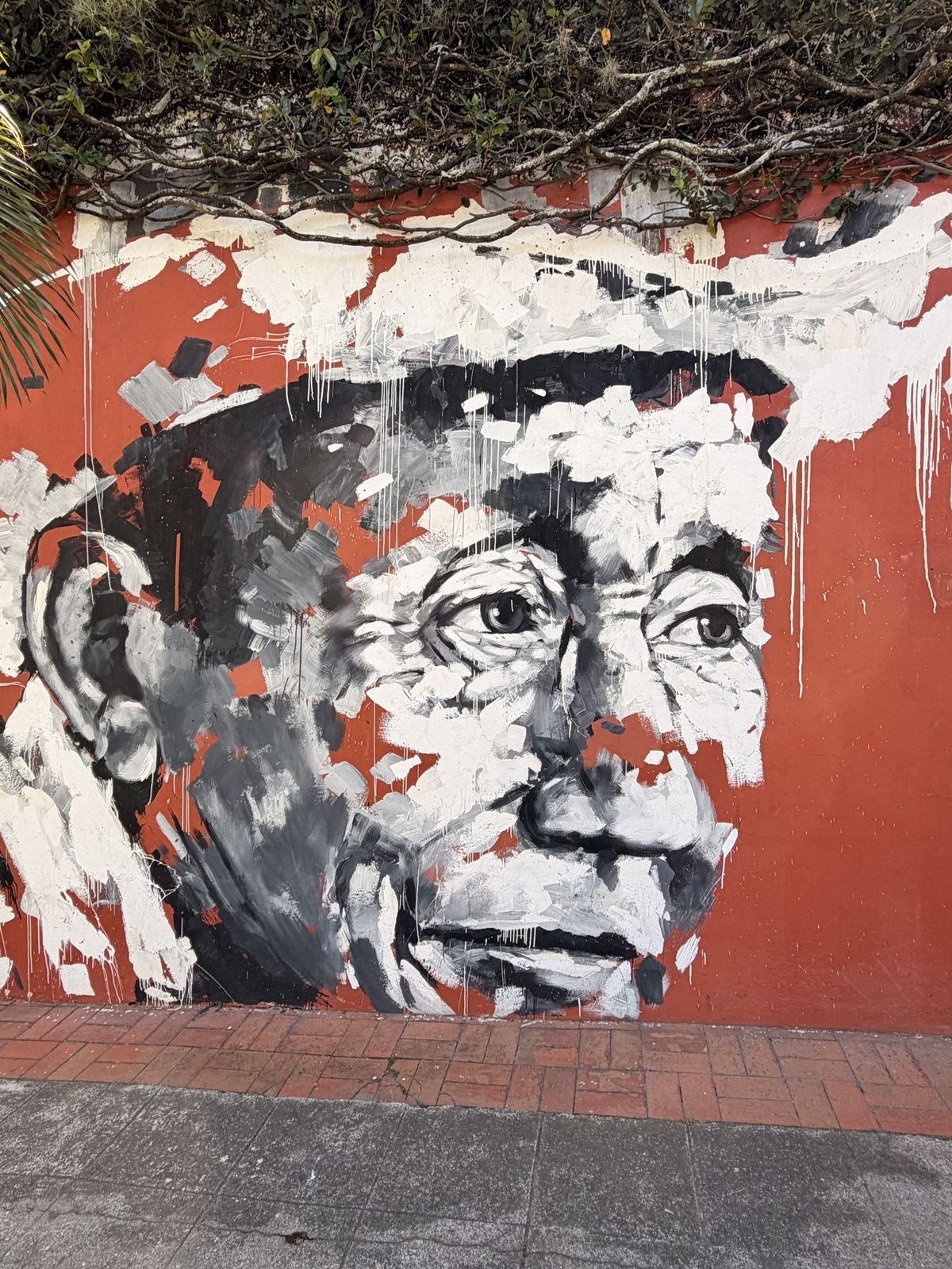A colorful mural on a wall along a San Salvador street