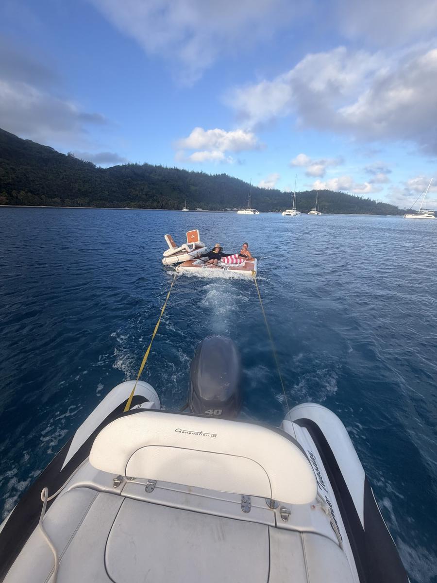 Turquoise water and a rocky, tree-covered point on Huahine