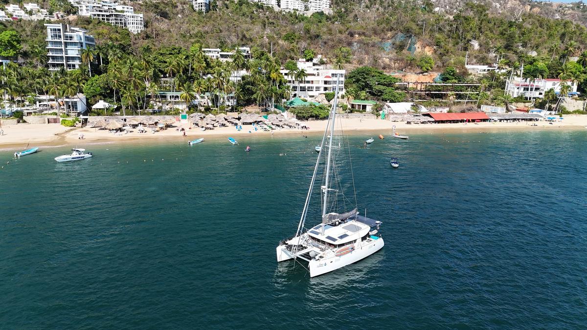 Aerial view of Acapulco's harbour, with the city and green hills around the bay