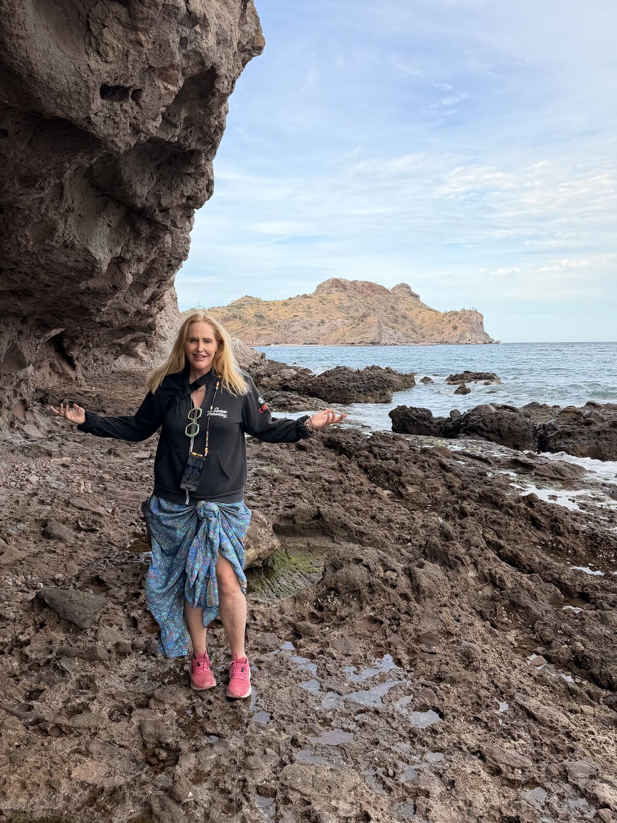 Agua Verde, a calm bay in the Sea of Cortez behind a rocky breakwater, with anchored boats and steep hills