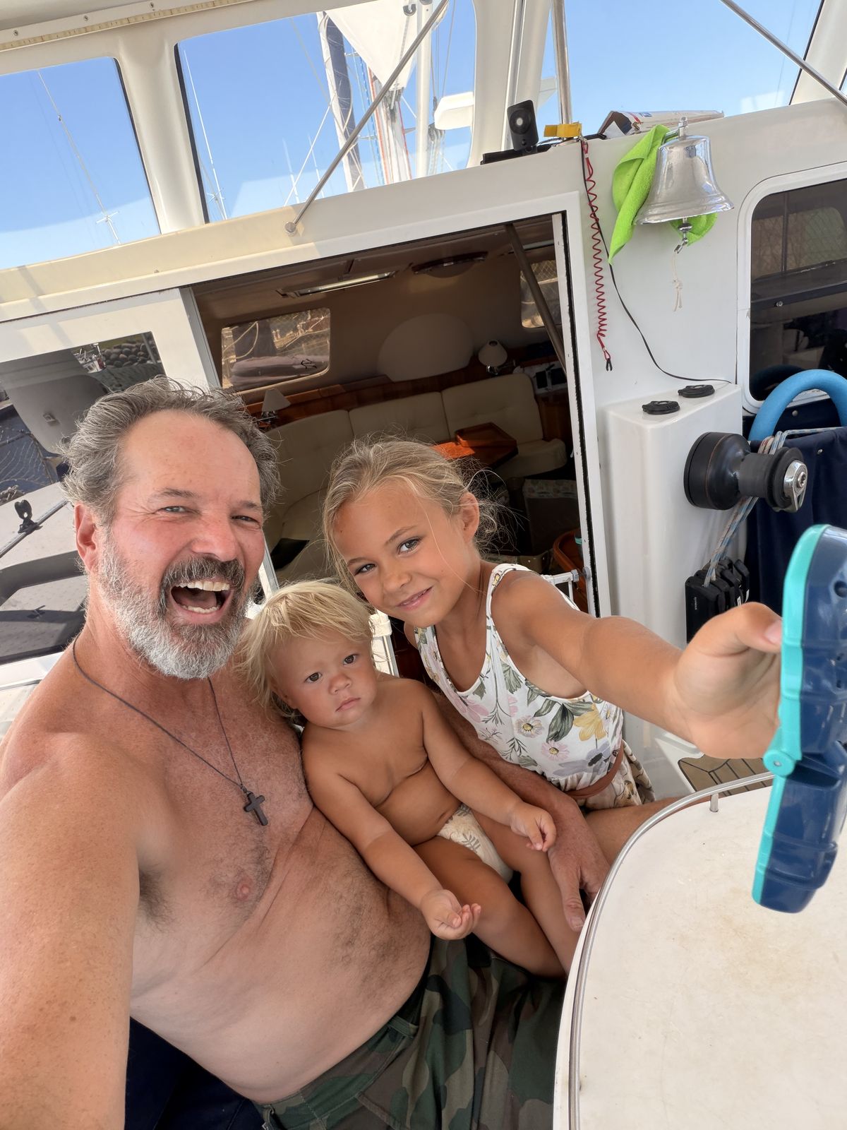Dave and Dani of Sea Again with their kids on a boat deck