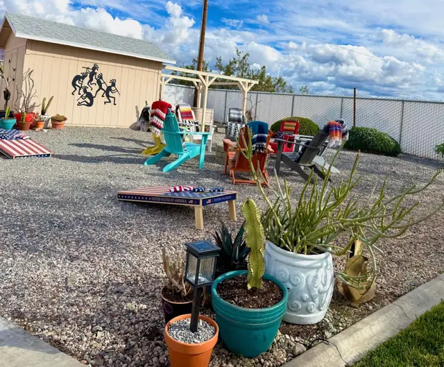 Cactus and succulent planters along the patio with seating beyond
