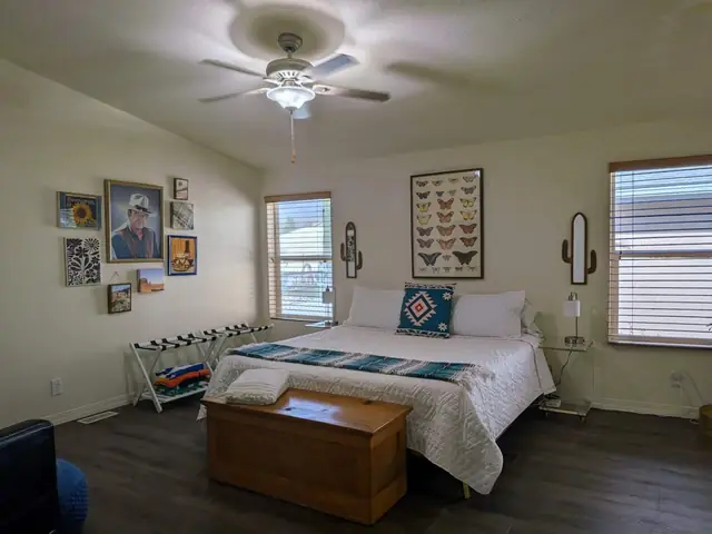 Bedroom with king bed, cedar chest and framed art