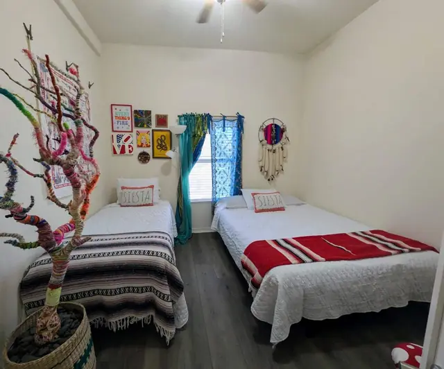 Bedroom with a twin bed and a full futon side by side