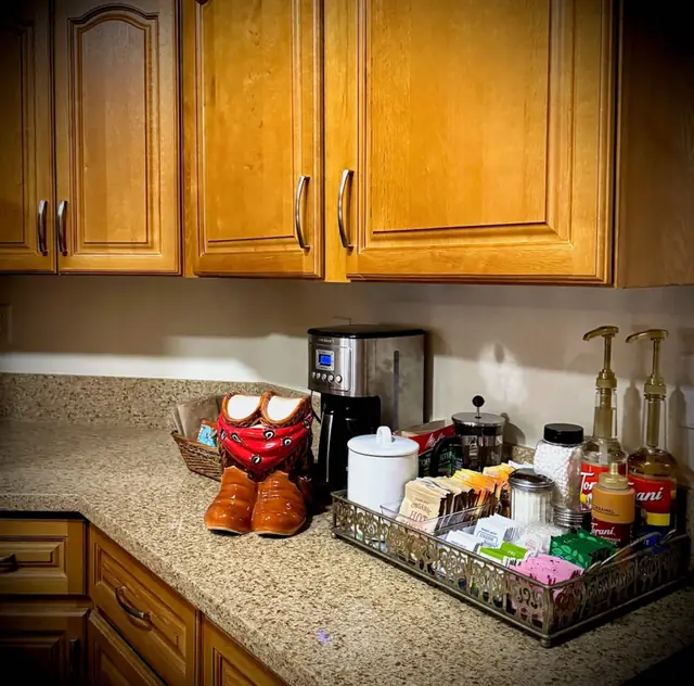 Coffee bar with grinder, syrups and cowboy boots on the counter