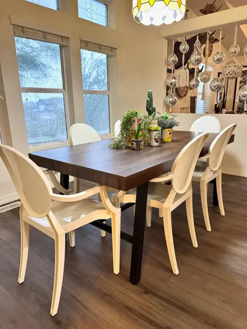 Dining table seating six under a beaded chandelier