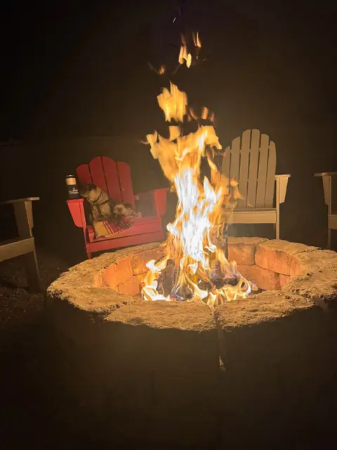 Mesquite fire burning in the oversized fire pit after dark