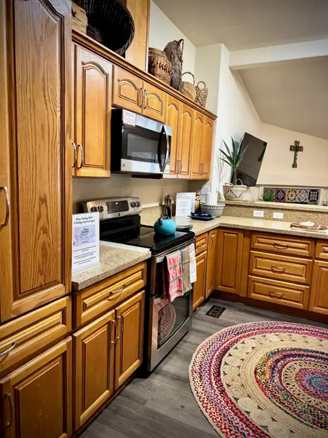 Kitchen range with double ovens and a braided rug