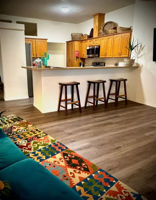 Kitchen bar seen across the living room rug