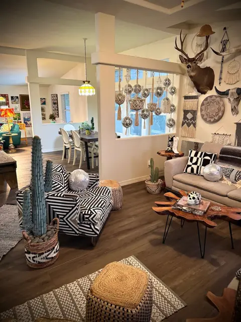 Second living room with cream sofas, woven hats and Western art
