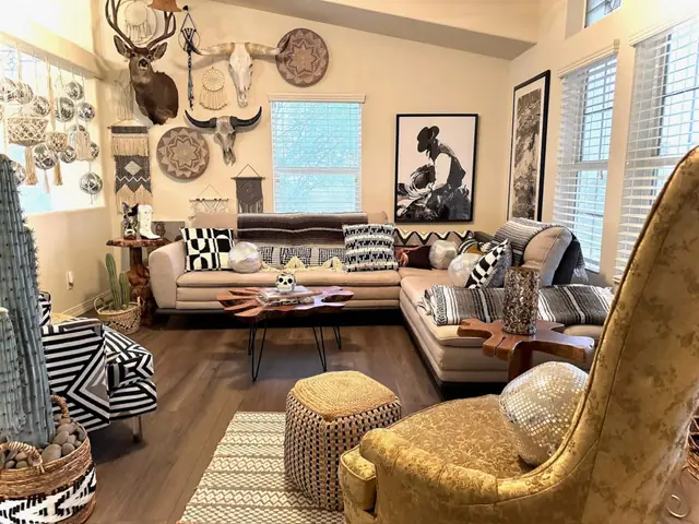 Formal seating area with cream sofas and a gallery wall of Western pieces