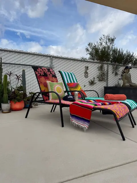 Poolside lounge chairs with blankets and cushions